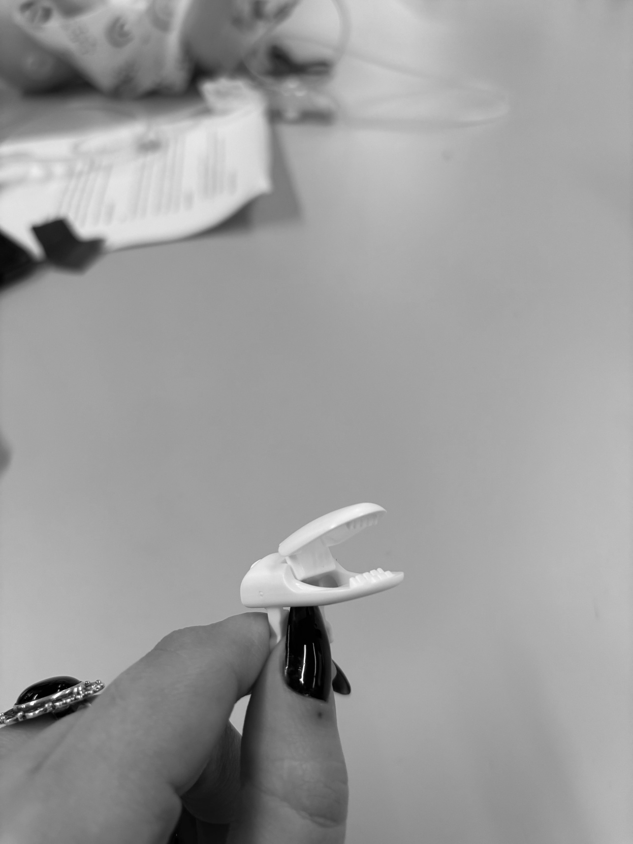 The original surgical clamp held in hand, showing scale and material
